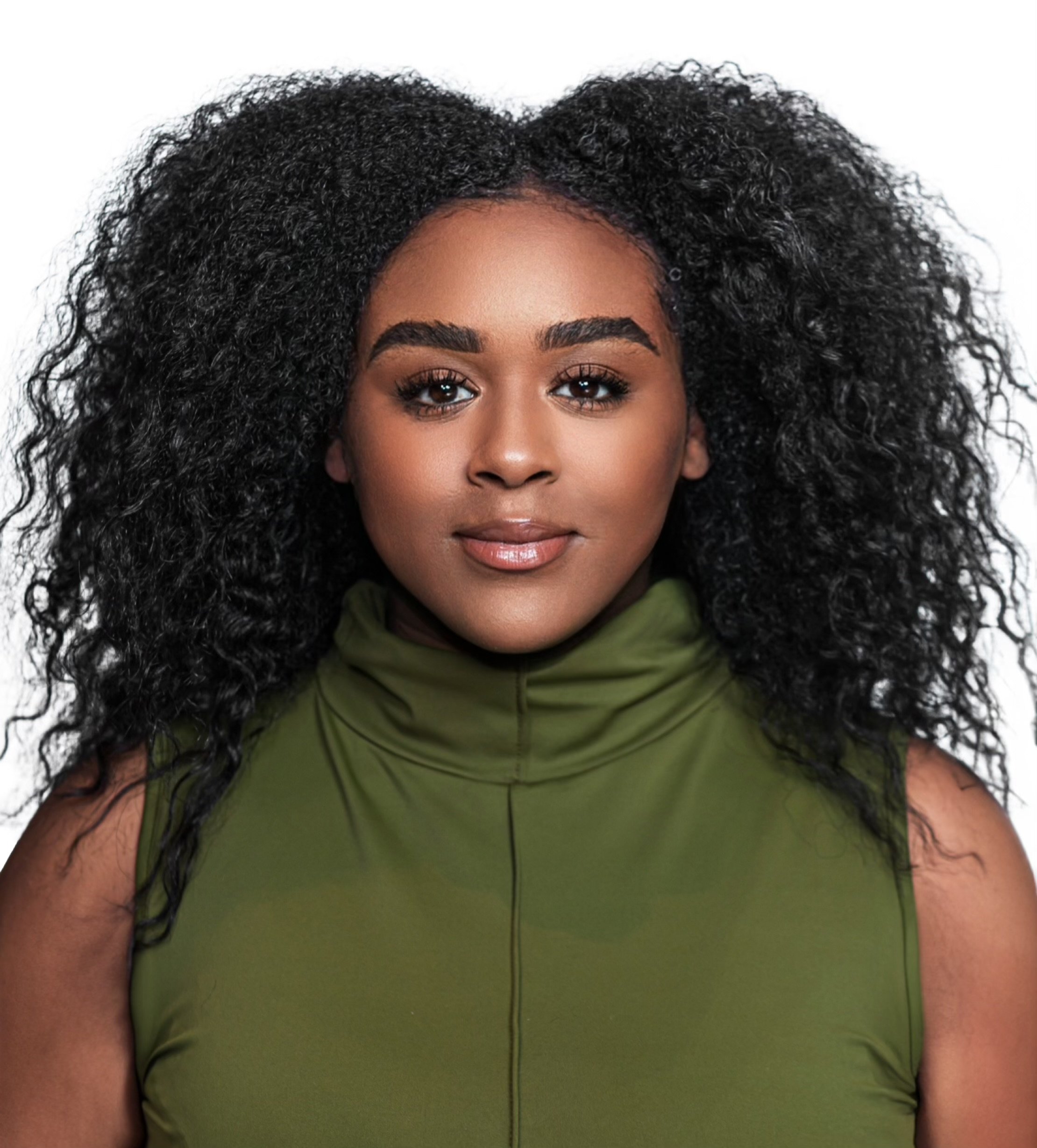 Close-up of a woman with dark skin and curly black hair, wearing a green top, looking at the camera with a neutral expression.