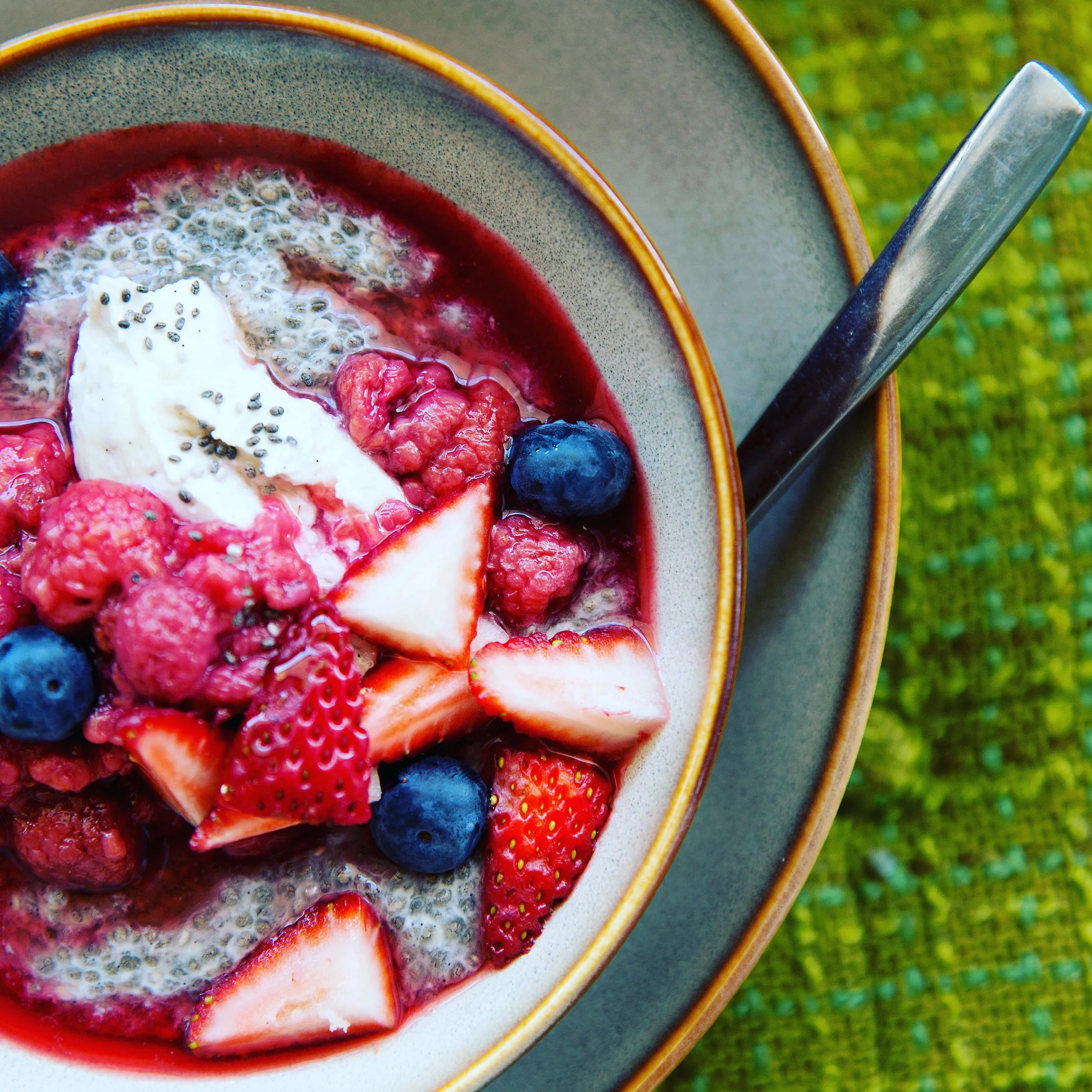 Chia seeds, coconut and freshly poached berries.