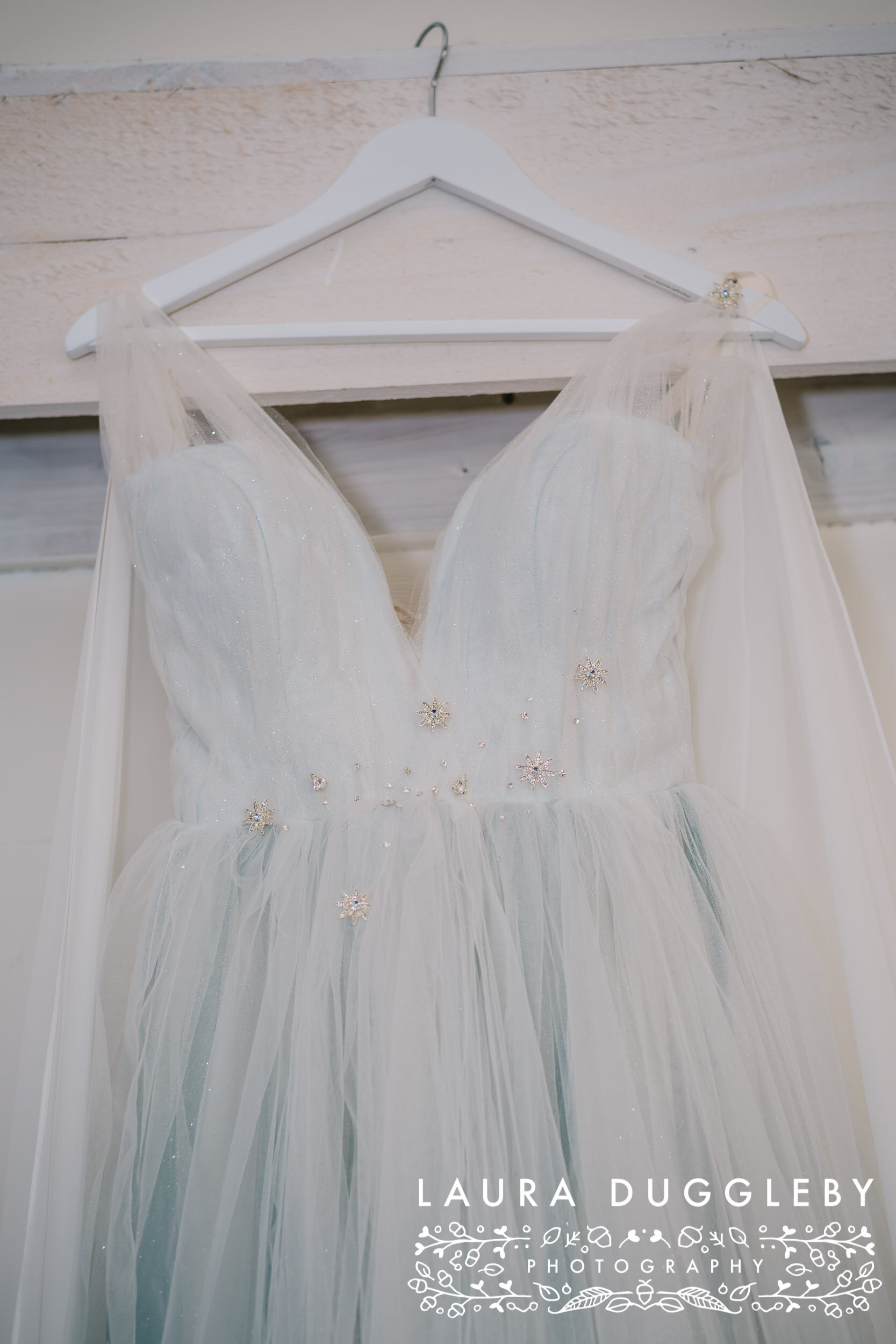 viking inspired wedding dress hung in bashall barn ceremony room