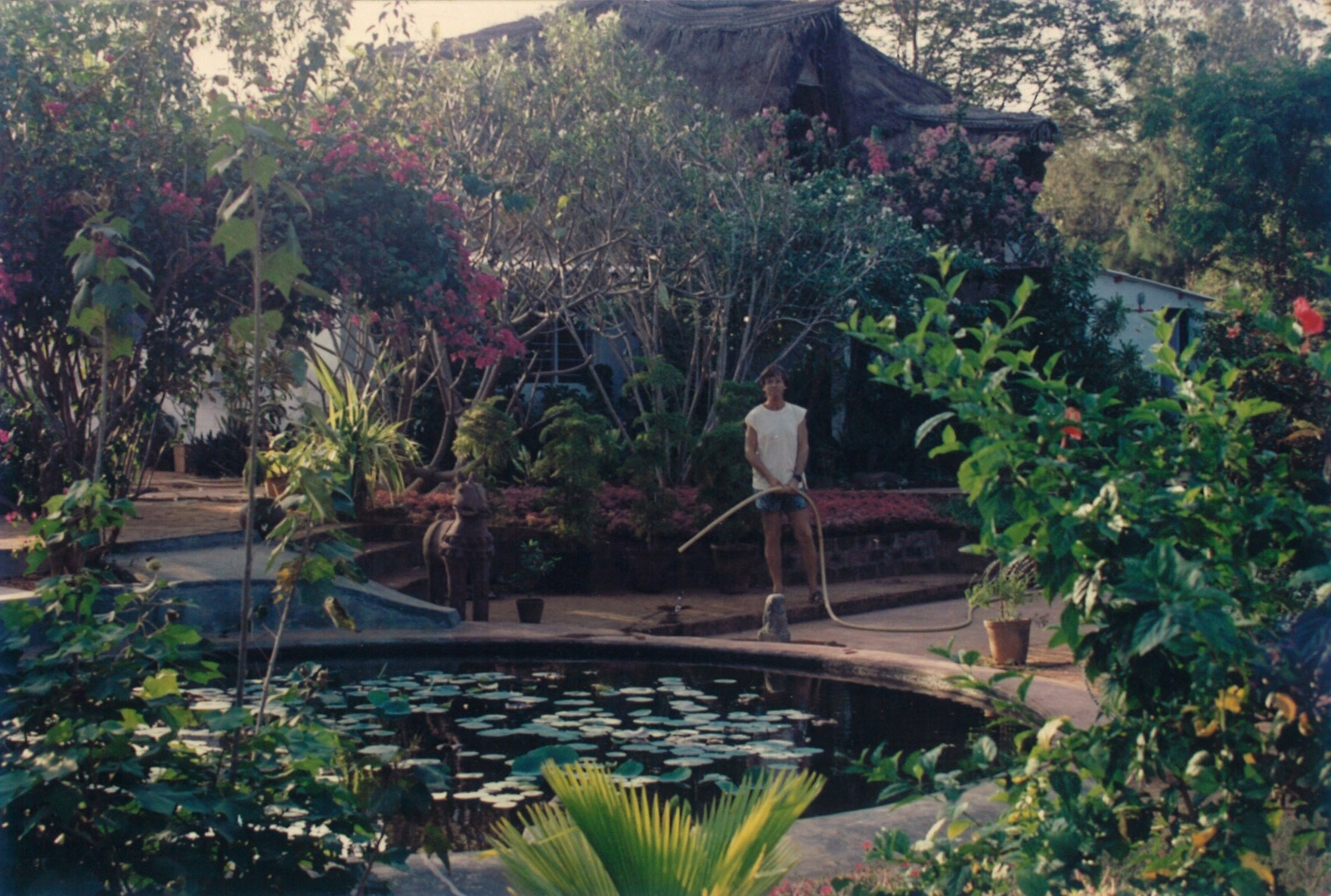 IGOR WATERING HIS GARDEN IN HIS ARSPIRATION HOUSE IN AUROVILLE INDIA - b .jpg