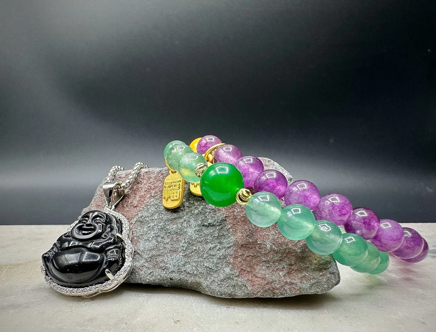 The BKB Prosperity Gem Bracelets blend natural energy with refined design. Crafted from green aventurine for luck and growth and amethyst for clarity and protection, each bracelet is finished with a gold-plated mini 福 (F&uacute;) charm, symbolizing b