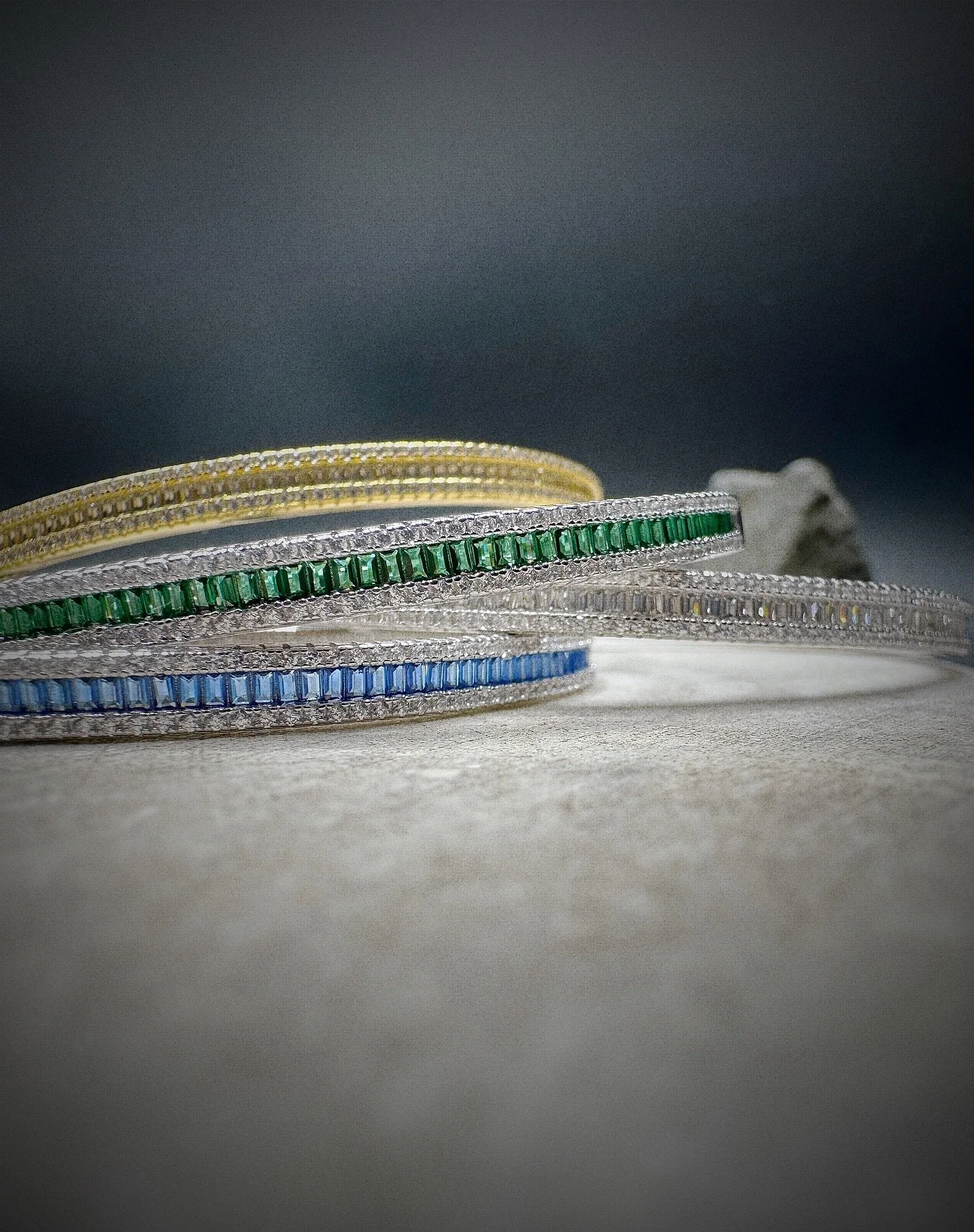 &bull; Elevate your accessory game with the BKB Birthstone 925 Gold Baguette Cut Bangle, a stunning piece that seamlessly blends elegance and versatility. Available in three captivating colors&mdash;Sapphire, Jade, and Diamond&mdash;this bangle is pe