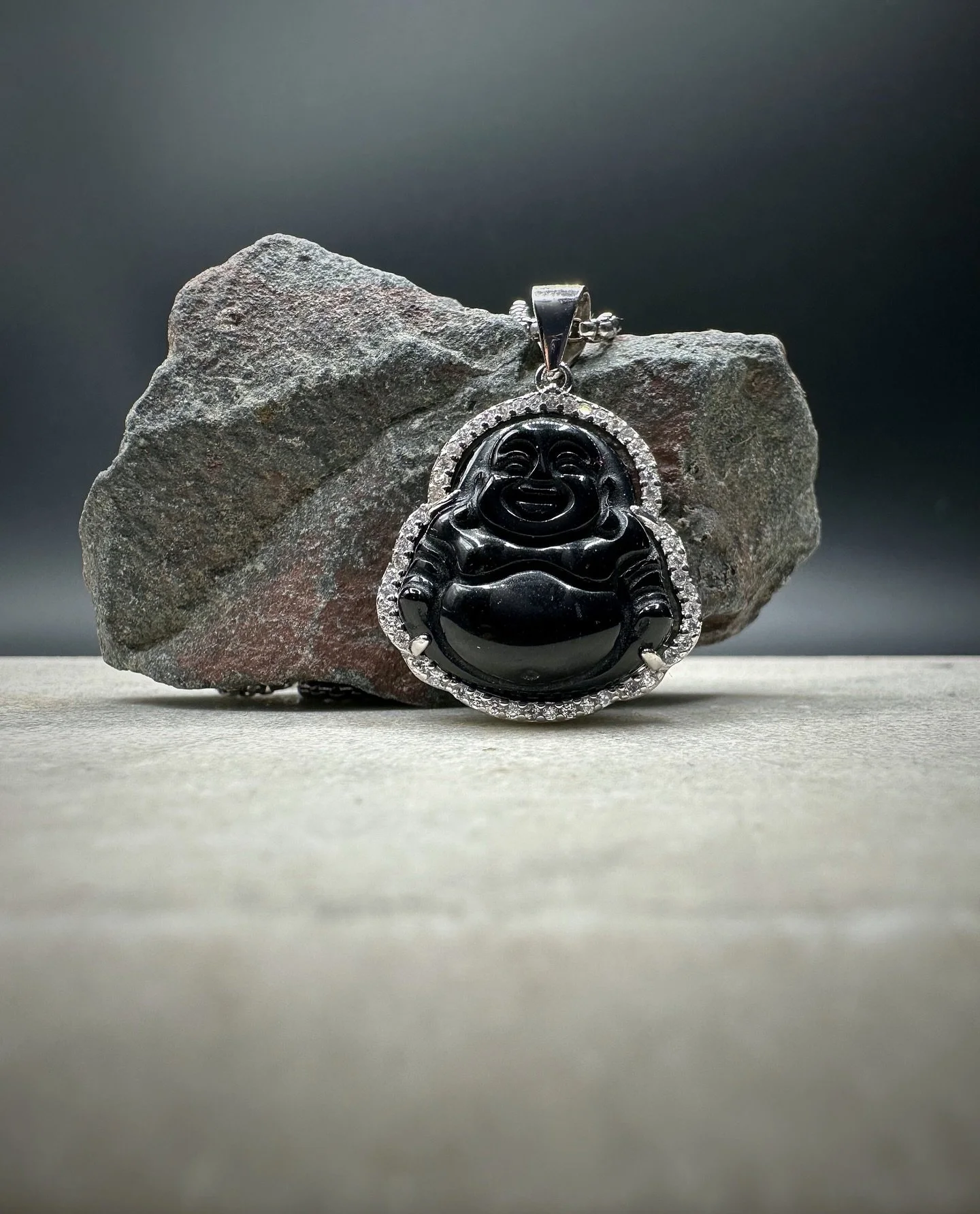 The BKB Onyx Buddha Necklace is crafted from solid 925 sterling silver, featuring a hand-carved black onyx Buddha charm surrounded by high-quality cubic stones that catch the light with subtle brilliance. Paired with a matching 925 silver chain, this