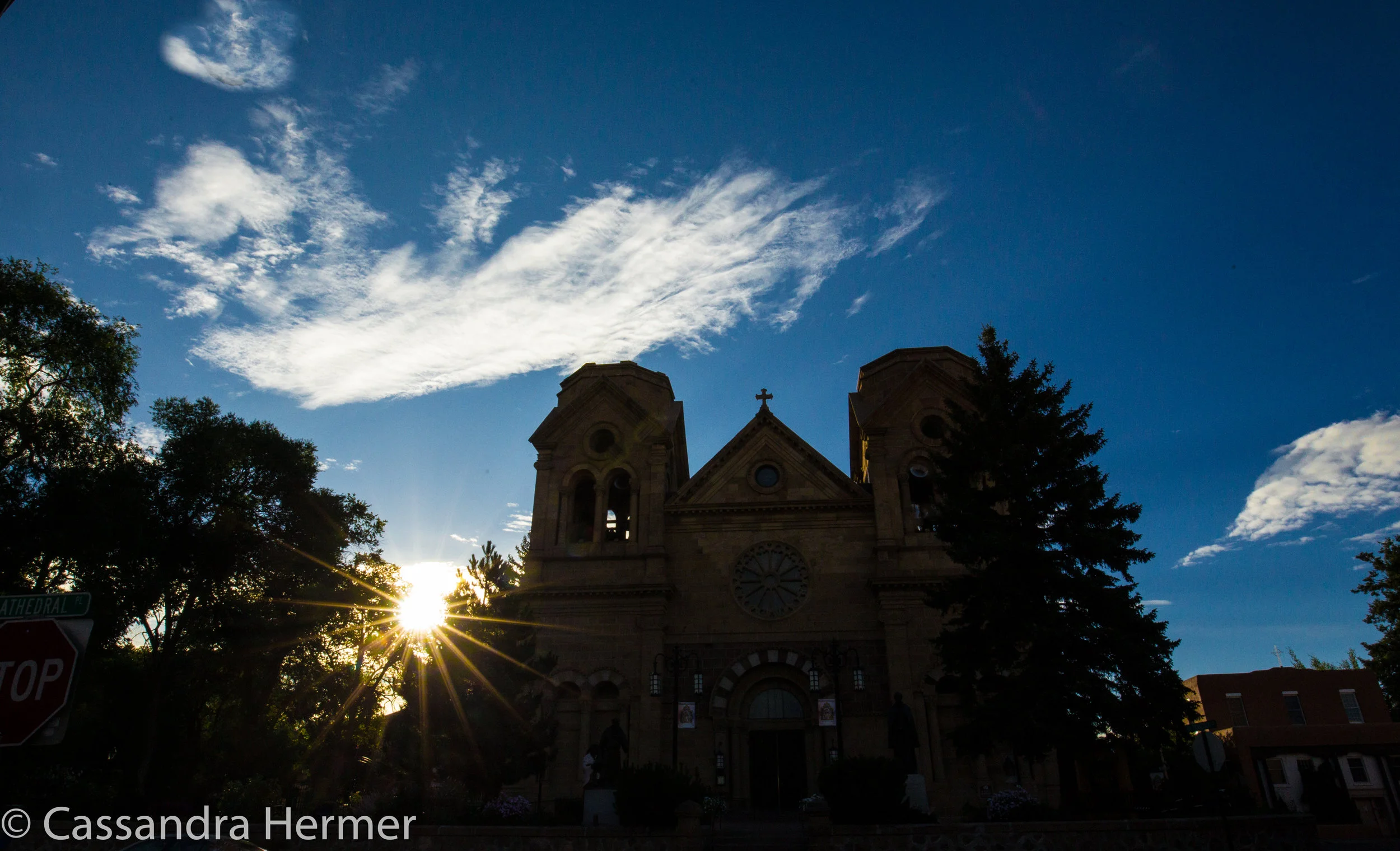  Day is starting with sunbeams by the church. Santa Fe, New Mexico 
