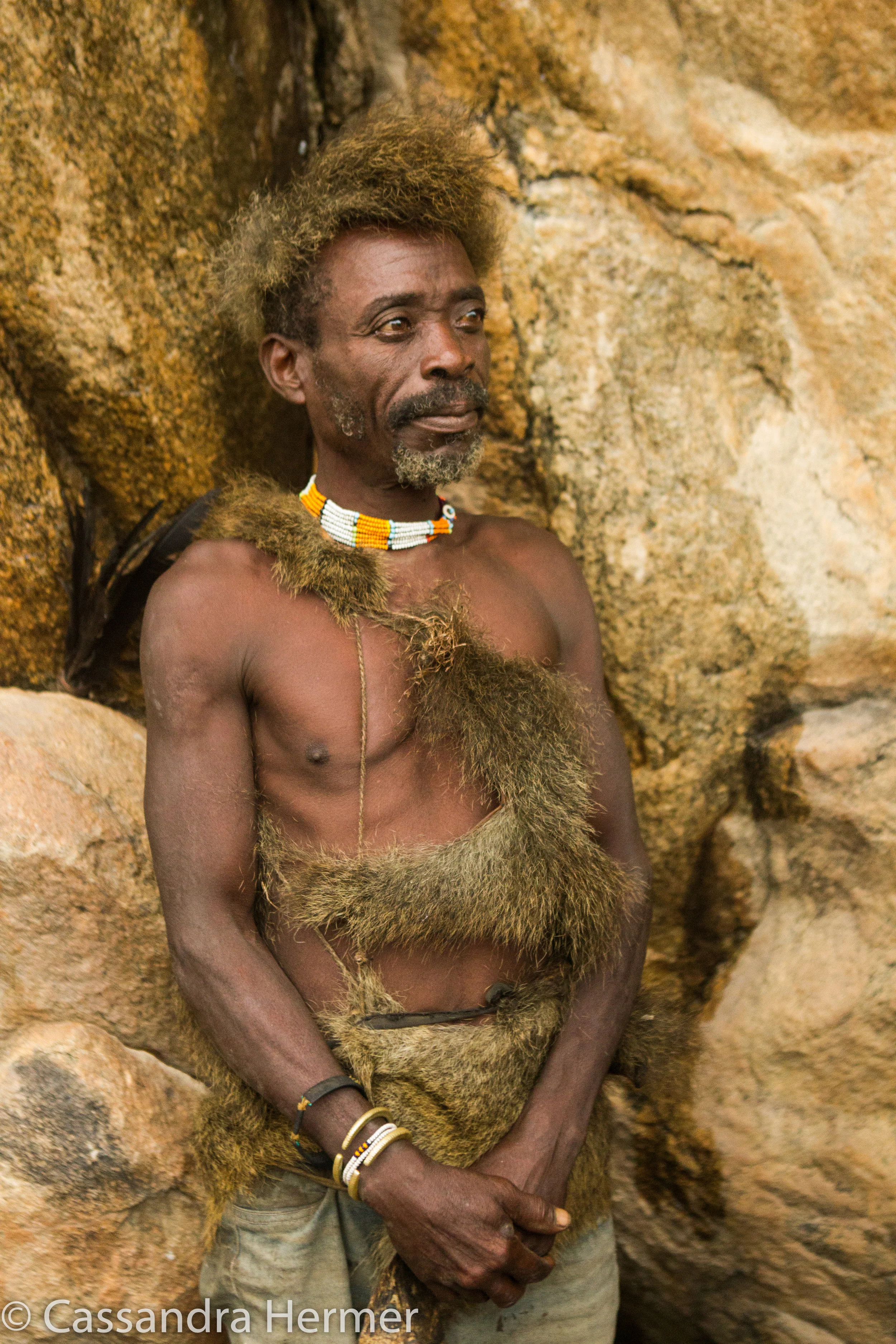  Hadazbe warrior. HIs clothing and head wear are of baboon fur. Most of the men wore this type of clothing. 