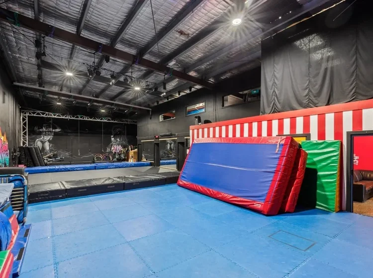 Training floor with tumbling mats and air track