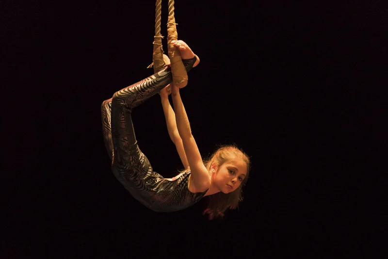 CircArts student performing on trapeze on stage