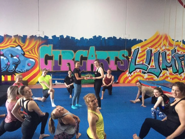 CircArts students warming up and stretching on the tumbling floor