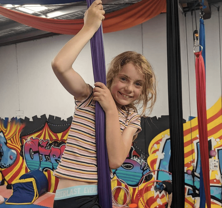 Girl climbing aerial silks