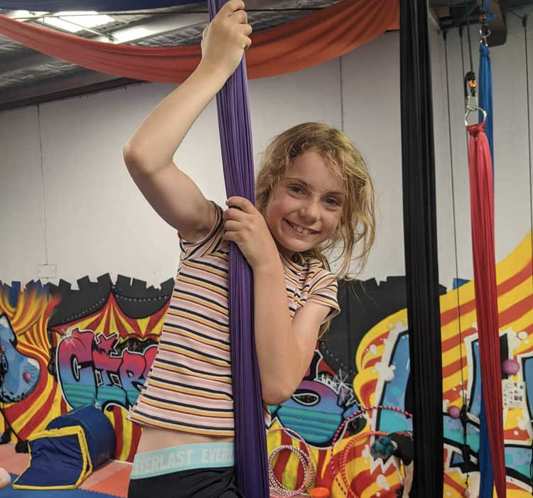 Girl climbing aerial silks