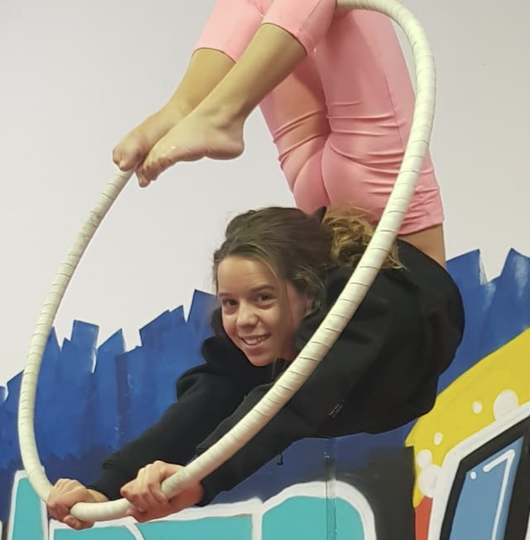 Child sitting in an aerial hoop