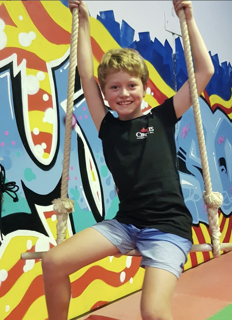 Smiling boy on an aerial rope