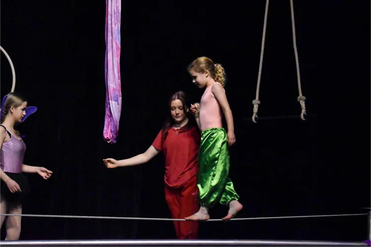 A tightwire walker on stage