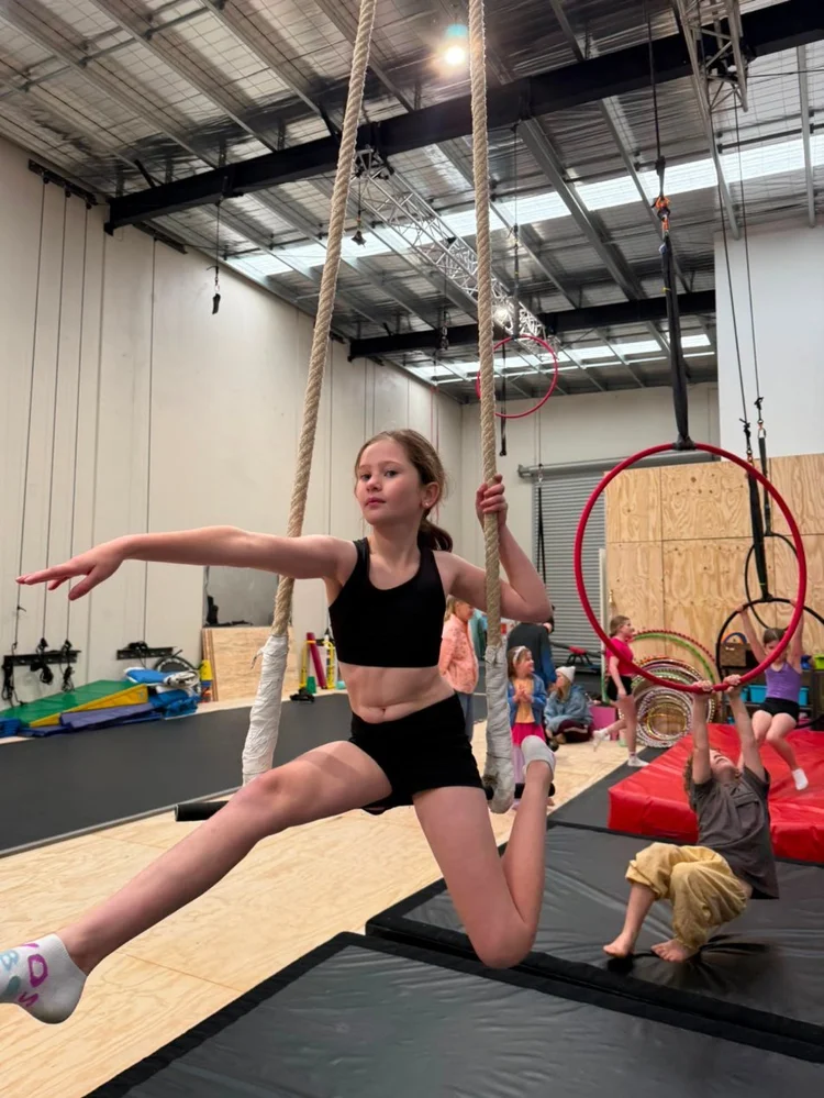 A student balancing on a trapeze in the CircArts Grovedale studio