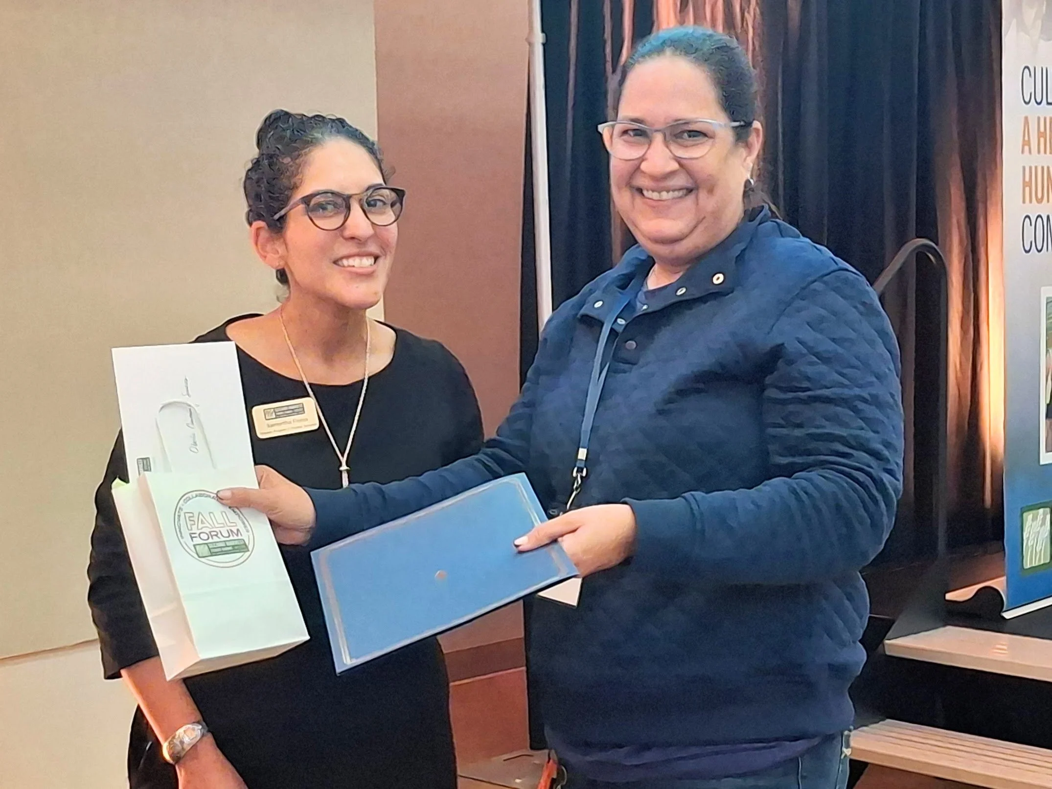 (OCS Food Programs Coordinator Suzette Sanchez is pictured accepting a milestone certificate from Sam Flores, Second Harvest Director of Program and Partner Services.)