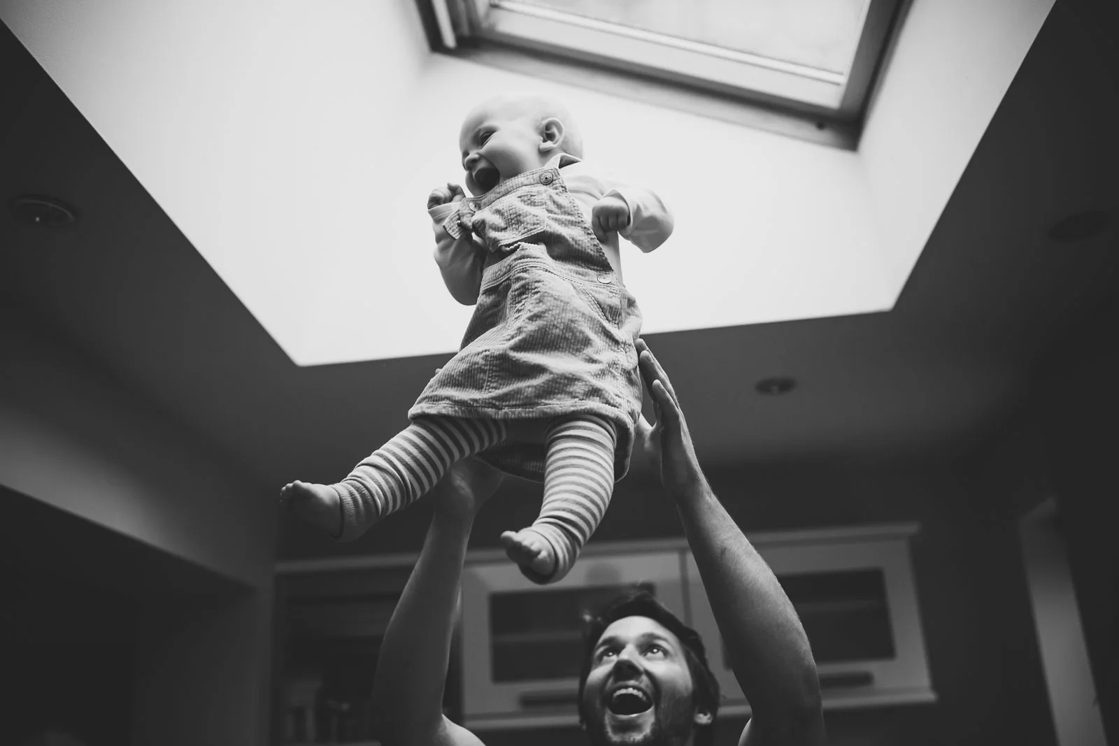 joyful-baby-thrown-in-air-family-portrait.jpg