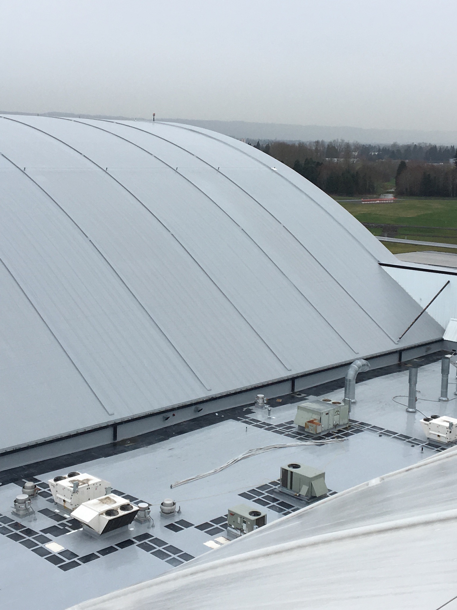 Horizontal lifeline on a barrel roof of a paint hangar for aerospace. 