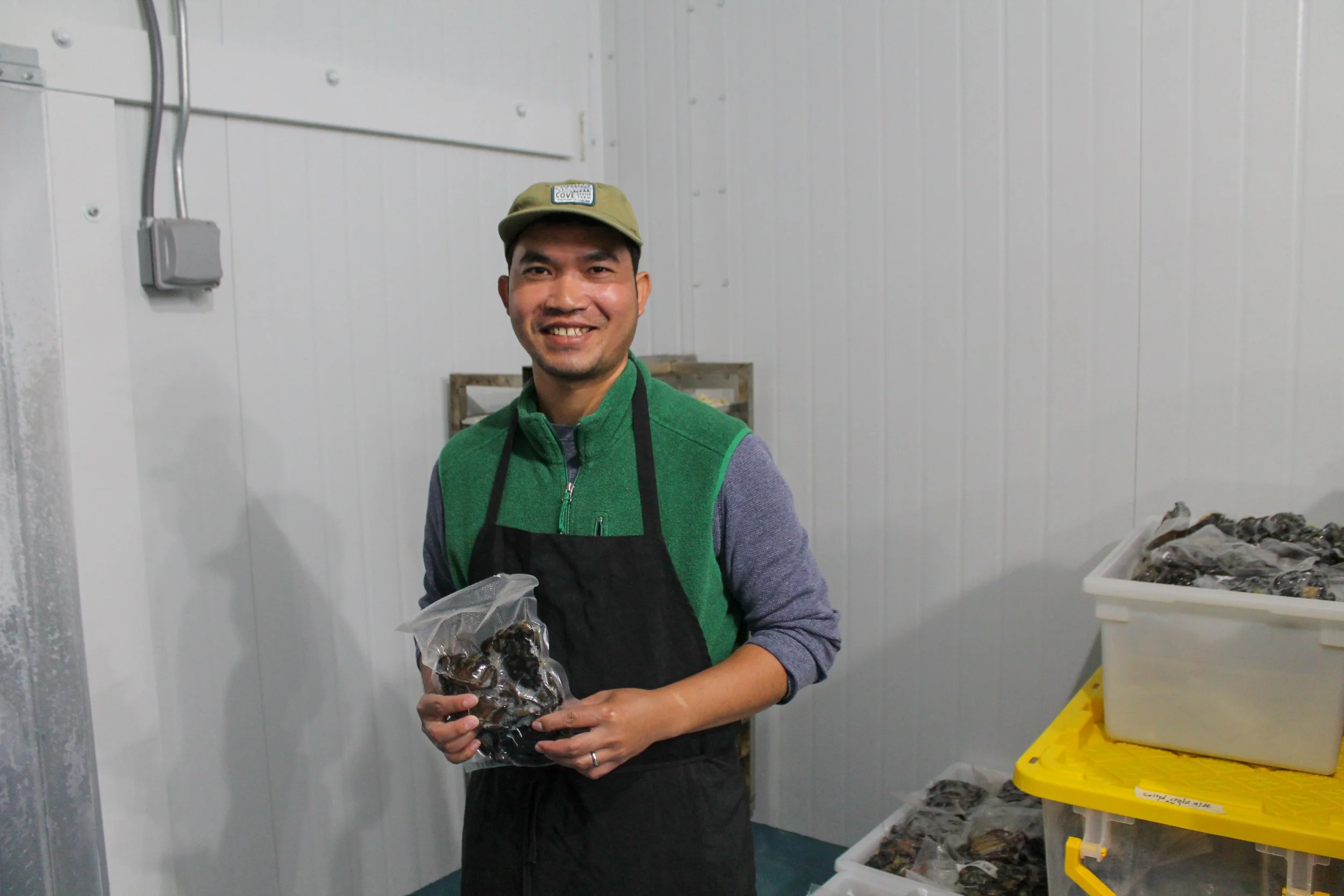 Bunly Uy of Khmer Maine holds green crab Kdam Prai