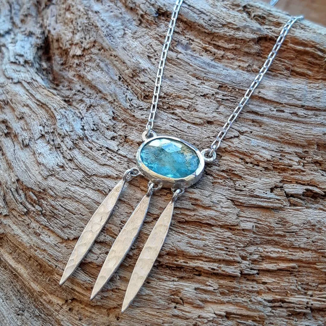 Because there's nothing more beautiful than the way the ocean refuses to stop kissing the shoreline, no matter how many times it's sent away. - Sarah Kay

Rose cut Aquamarine with hammered silver tassels.

#laineyraegoldsmith #jewellery #jewelry #jot