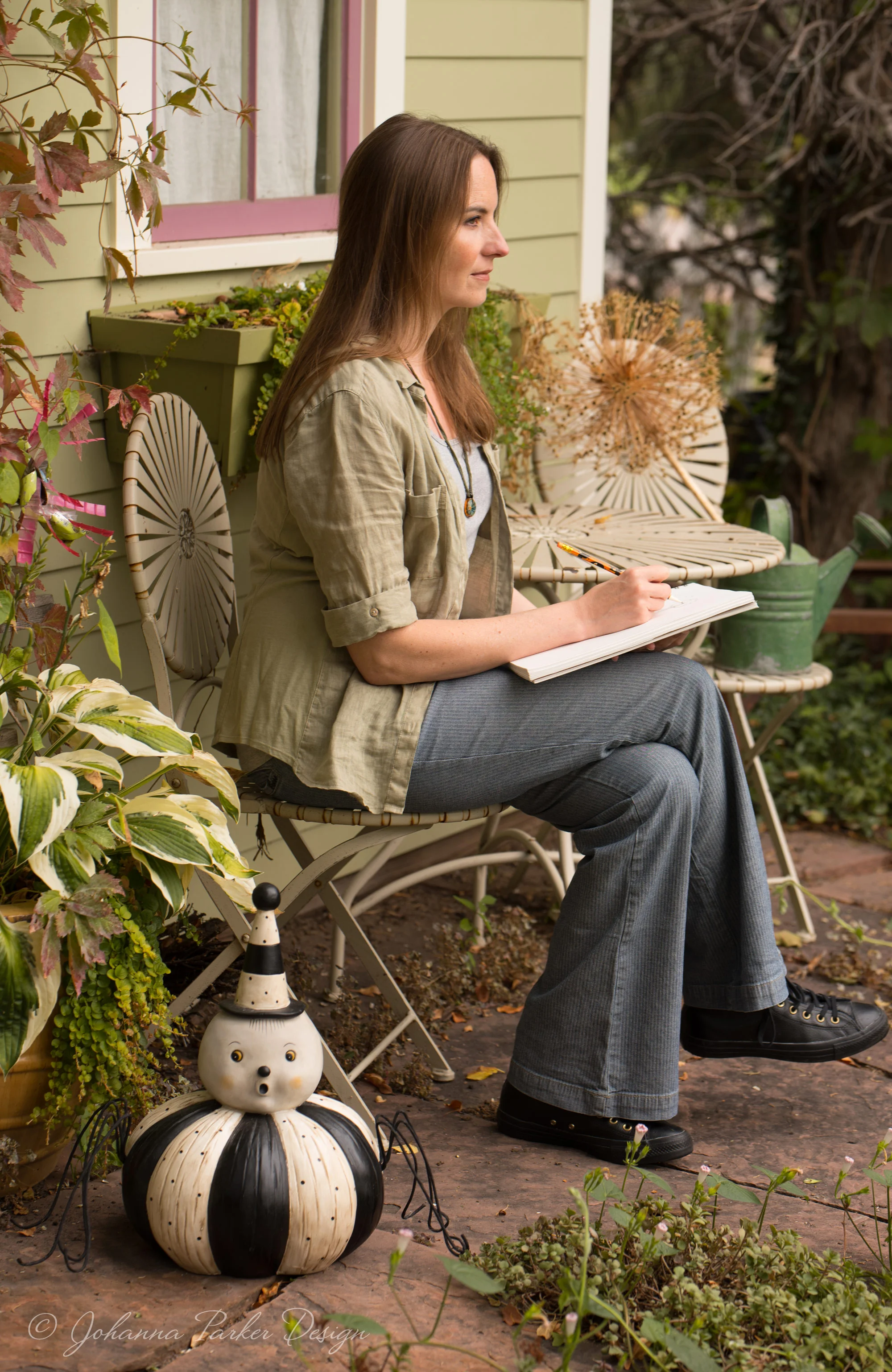 Me again at a little backyard garden table, staring off into imaginary land like I often do... Giant spider in tow....This feature was so last minute, I didn't have time to iron my clothes. Bad weather was rolling in, and we just had to wing it... I rarely iron anyway.... :D