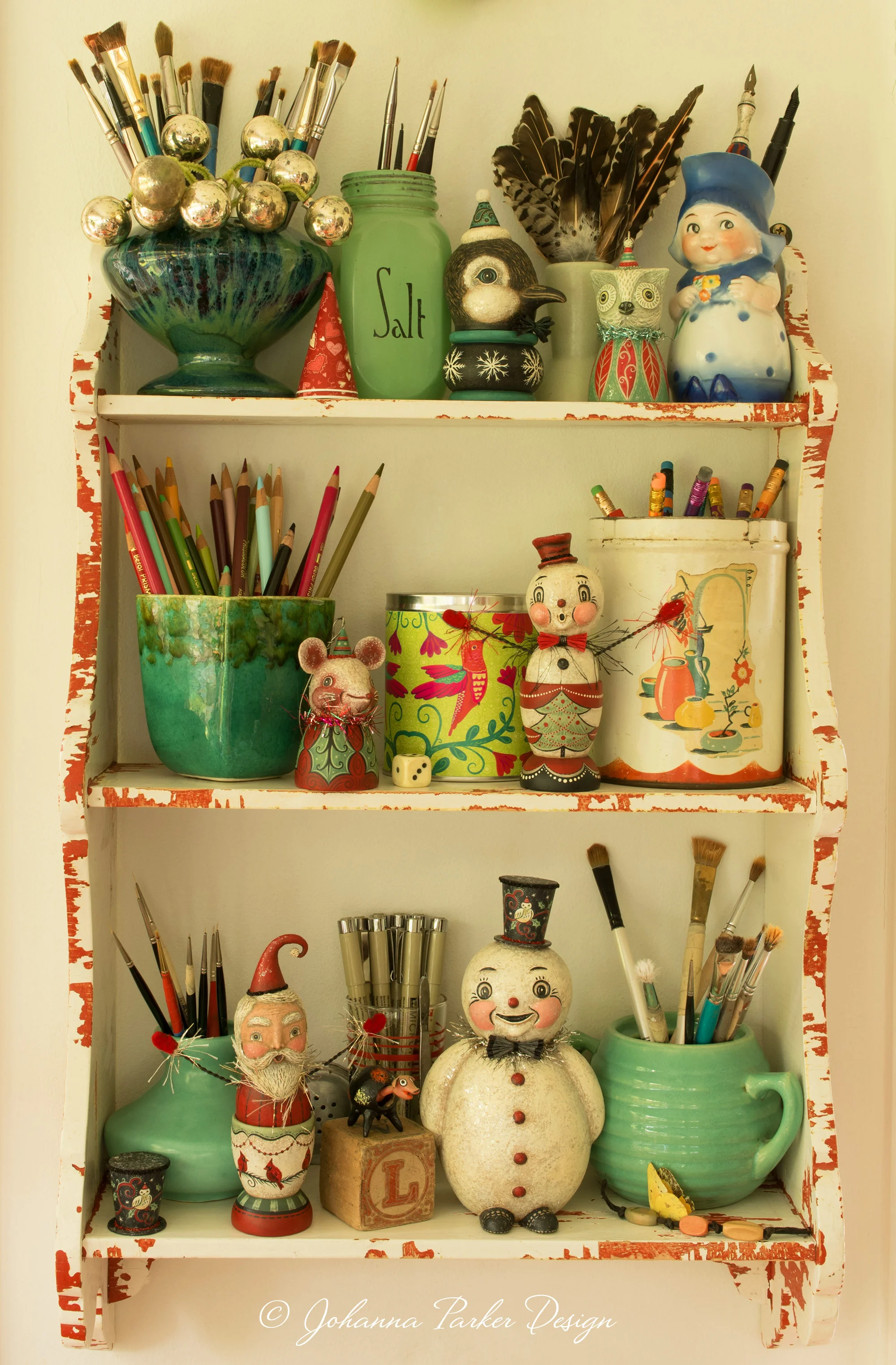 An old family shelf now houses both art supplies and one of a kind folk art pieces.