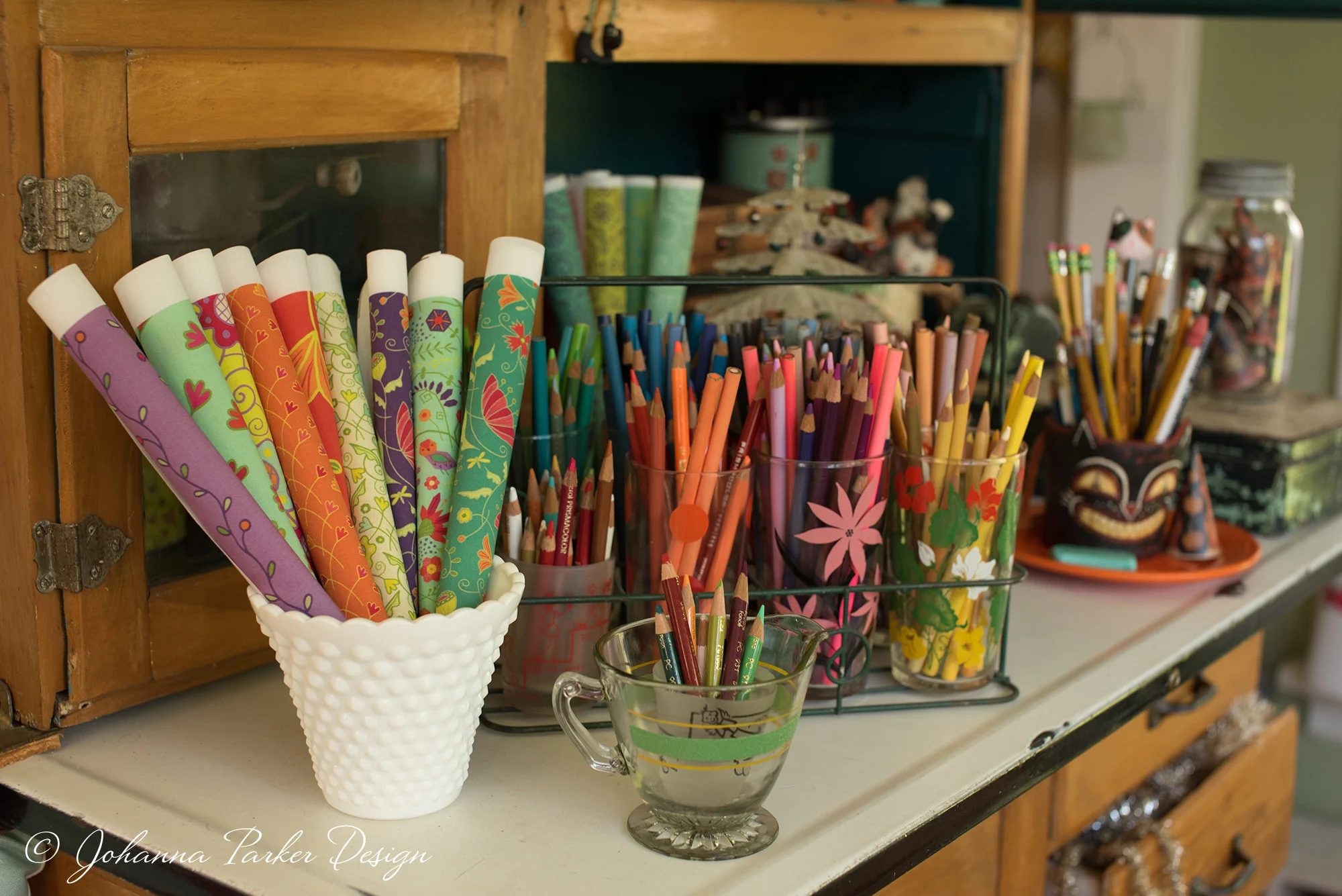 A hand-me-down hoosier hutch from mom is now the keeper of art supplies, fabric swatches & collectibles that inspire new designs.