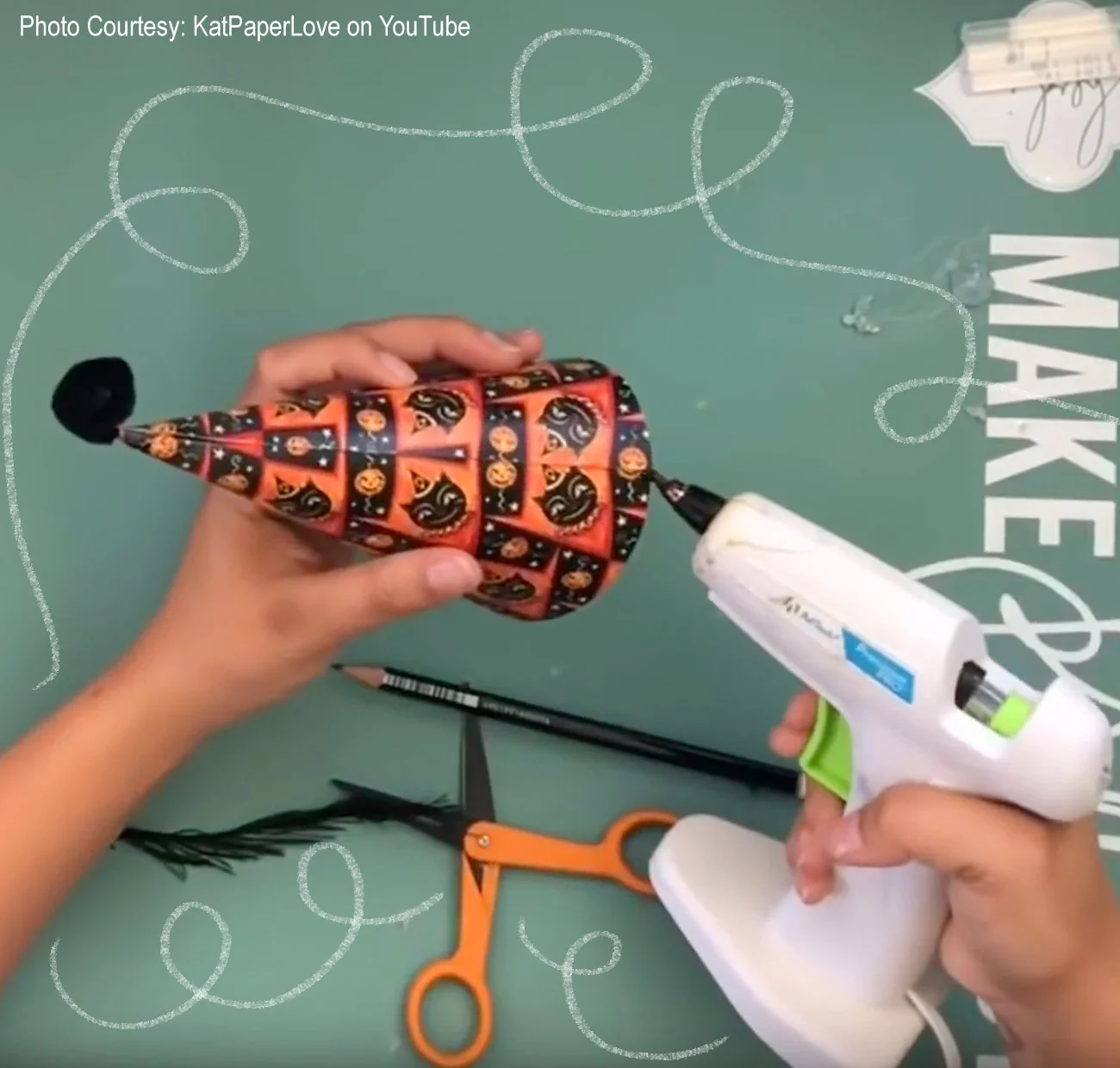 Screen capture from Abby’s How-To video, showing how she uses her glue gun to make the magic happen…