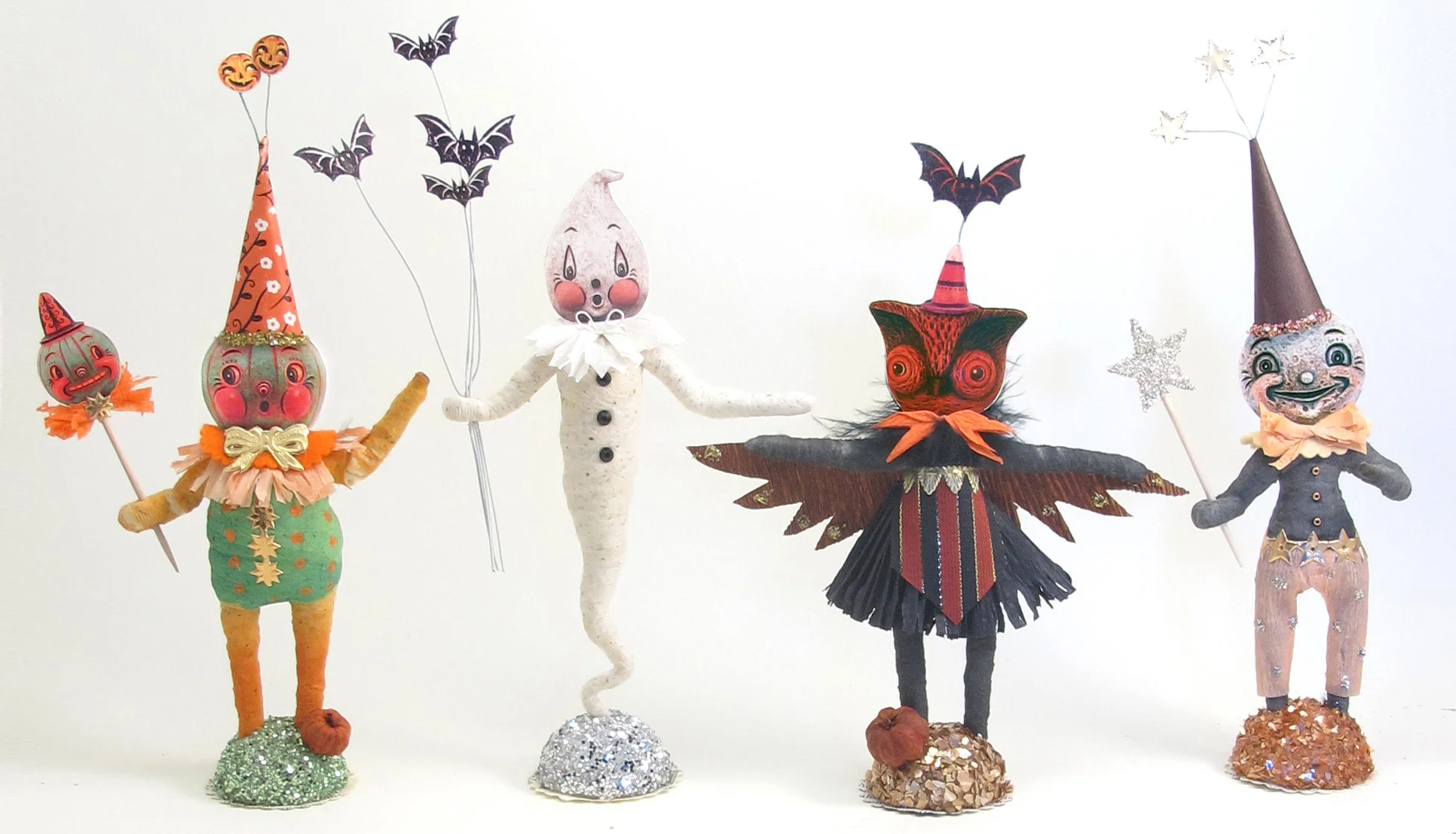 A classic green jack-o’-lantern, ghost, owl and moon make for a playful family of characters! Each is handmade from Vintage by Crystal, and they do look spooktacular, clustered in groups!
