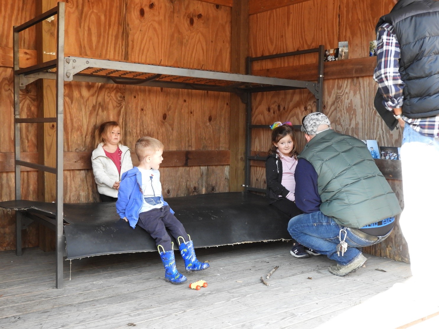 Grandchildren and Great Grandchildren try out the bunk bed donated by the Weiford family and placed in the Reger family shelter by Giles Wright and Greg Edwards.