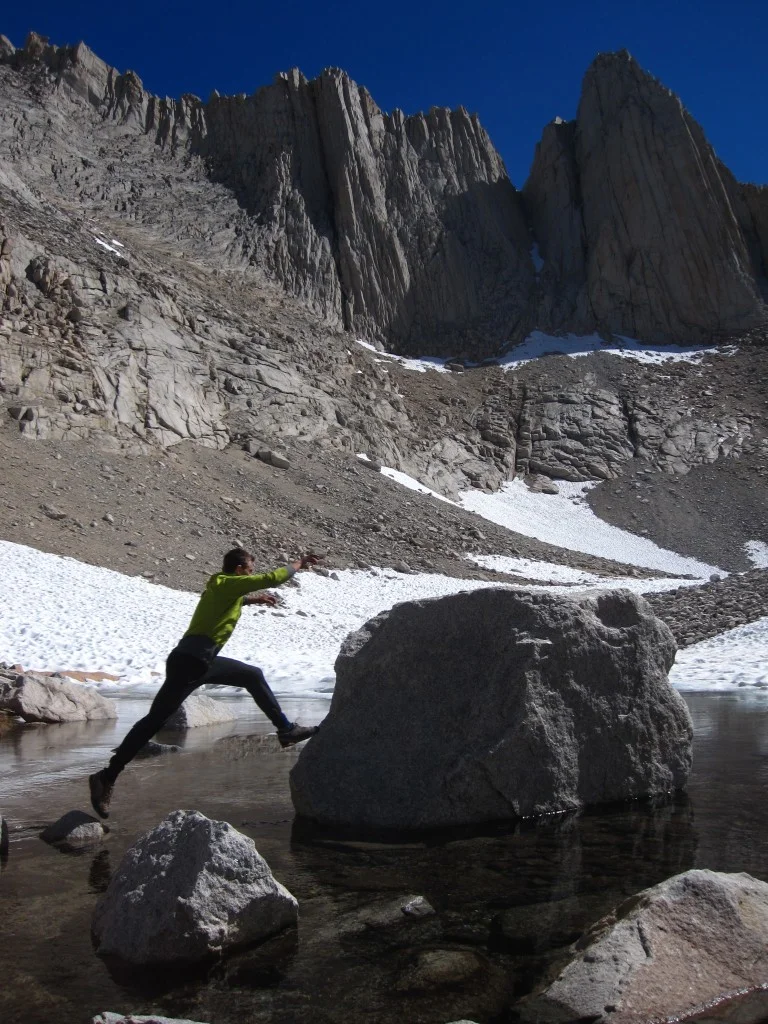 playing around the pool with the West Face of Mt. Russel in the background
