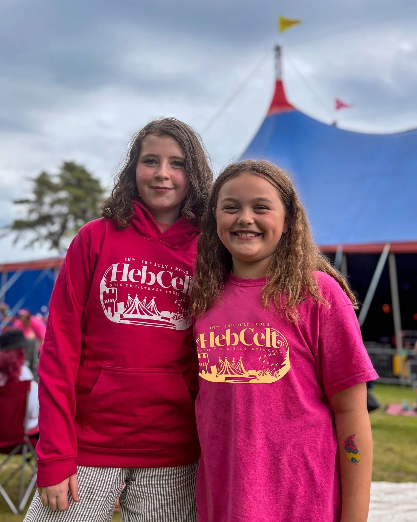 Girls in hoodies outside a festival tent in Stornoway