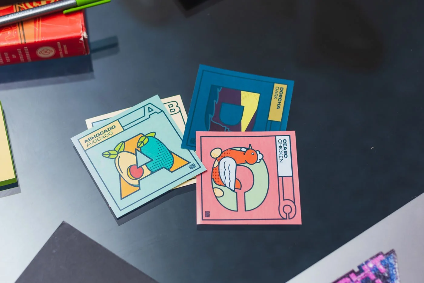 Bright bold stickers in the Scottish Gaelic Language on a table in a graphic design studio