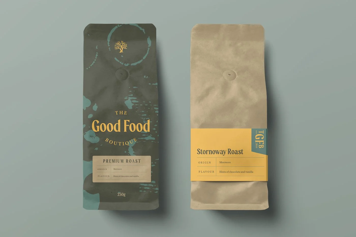 Two coffee bags with labels, one black with gold and cream accents reading 'The Good Food Boutique' and 'Premium Roast', the other beige with yellow and blue labels reading 'Stornoway Roast', both originating from Morocco and flavored with hints of chocolate and vanilla.