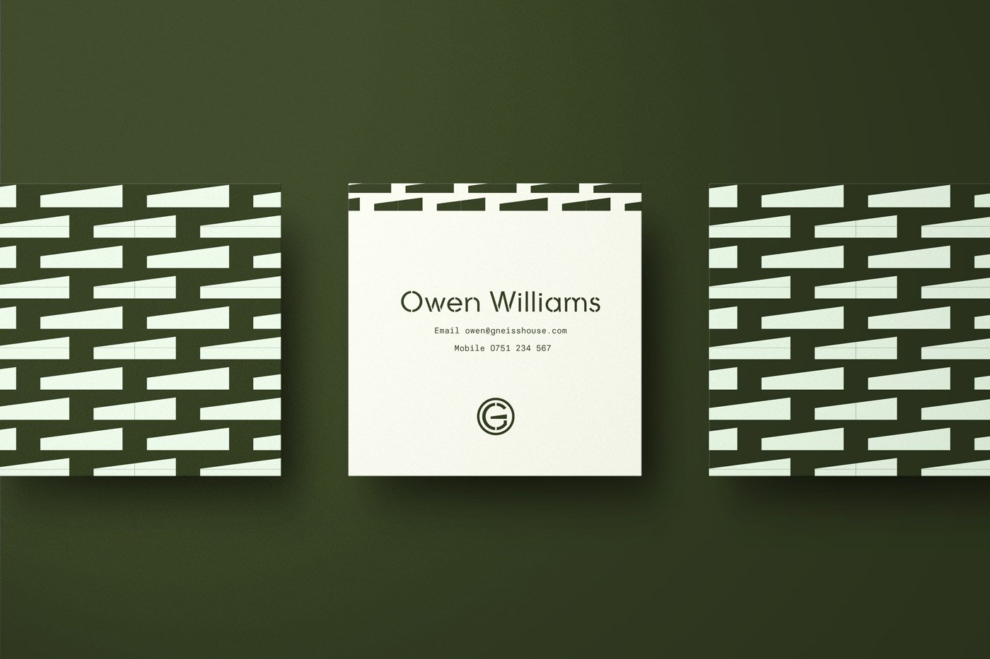 Business card for Owen Williams with contact details, centered on a white background, flanked by patterned black and white designs on a dark green surface.
