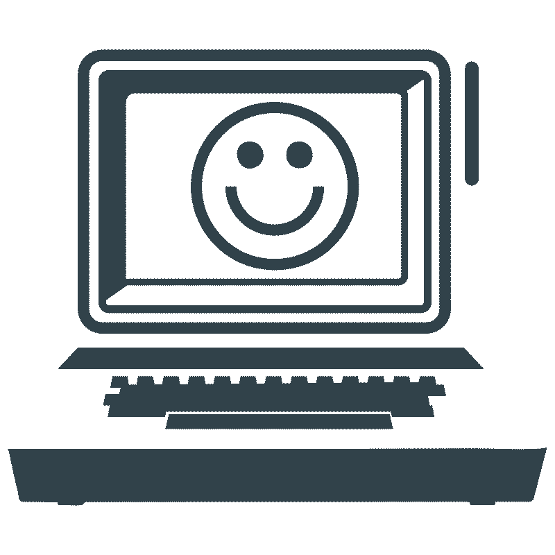 A computer monitor displaying a smiley face on the screen.