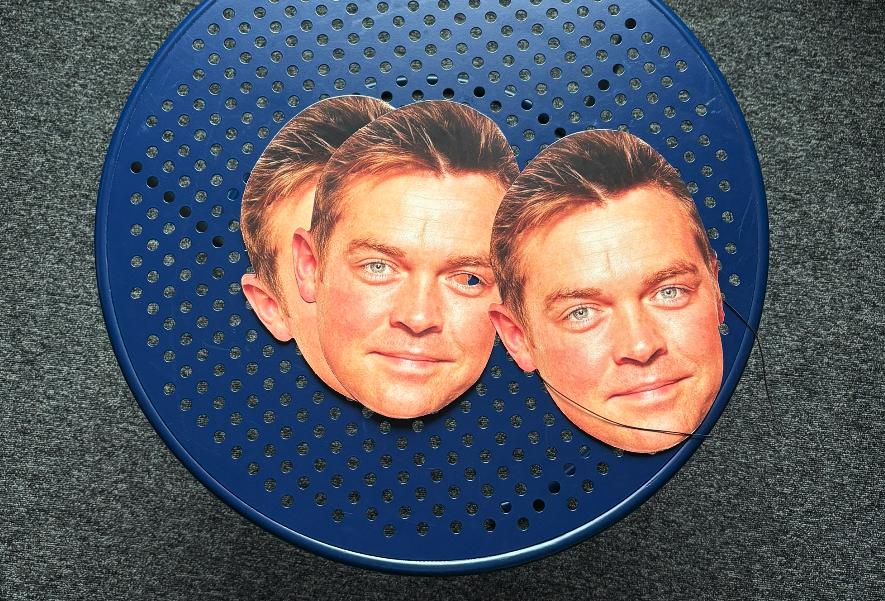 A table with some masks containing the image of Stephen Mulhern