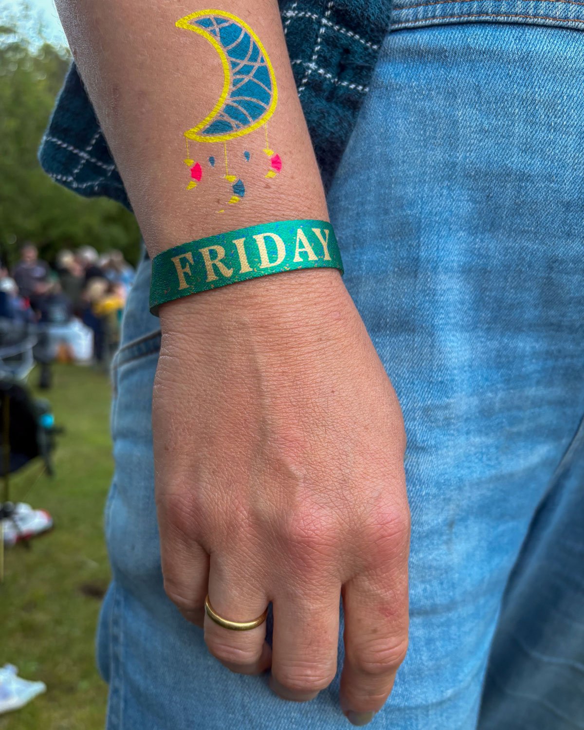 Women at HebCelt festival wearing wristband design