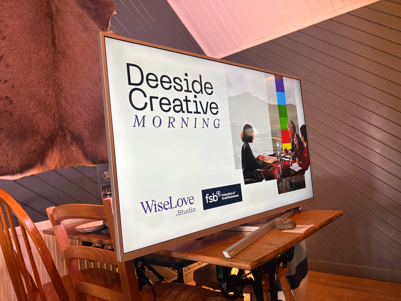 A TV monitor displaying a holding screen for Deeside Creative  at The Boat Inn in Aboyne