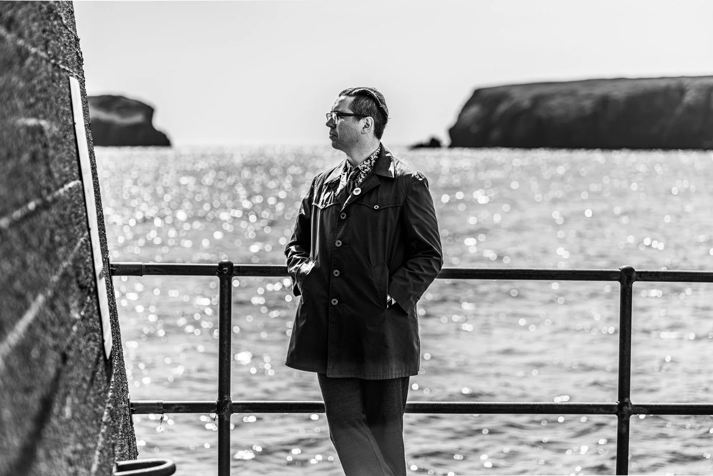 A man on a Bayble pIer in the Isle of Lewis