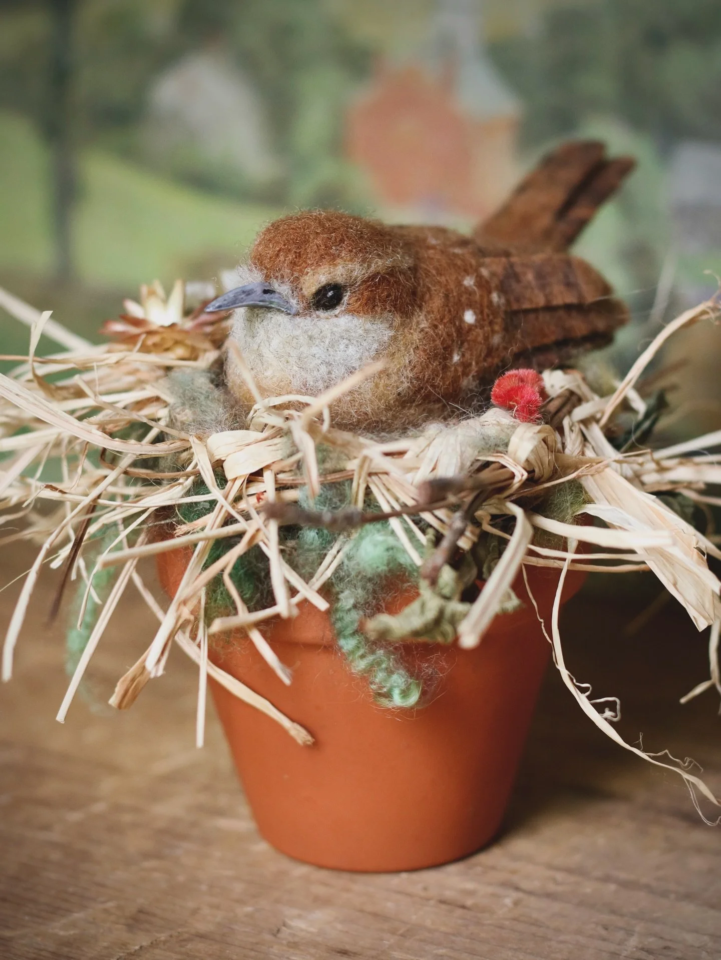 The process of needle-felting is slow and peaceful&mdash;taking loose wool and turning it into a tiny soul. This Carolina wren is cozy inside its nest of raffia, pine needles, wool locks, accented with sweet dried flowers and leaves. But soon this li