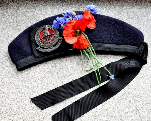 My dad's Glengarry with my grandfather's cap badge just after a memorial dedication at Hill 70, France. Blue flowers of Remembrance and a poppy given to me by the local mayor.