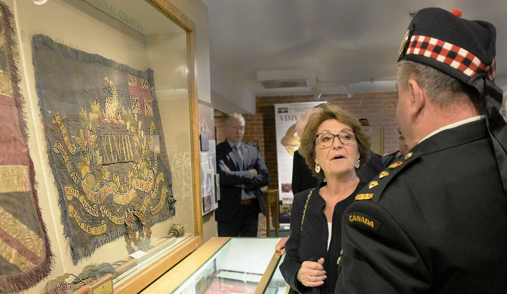 Hon. Col. Elms explains the Regimental Colours on display to HRH 