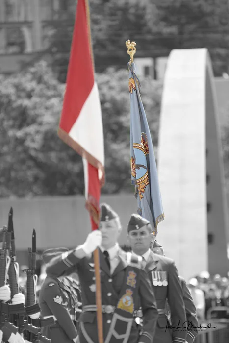 Her Majesty The Queen's Colours and the new RCAF colours are paraded before all assembled troops for the first time