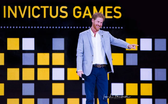 HRH Prince Harry points and smiles at an athlete from Team Australia