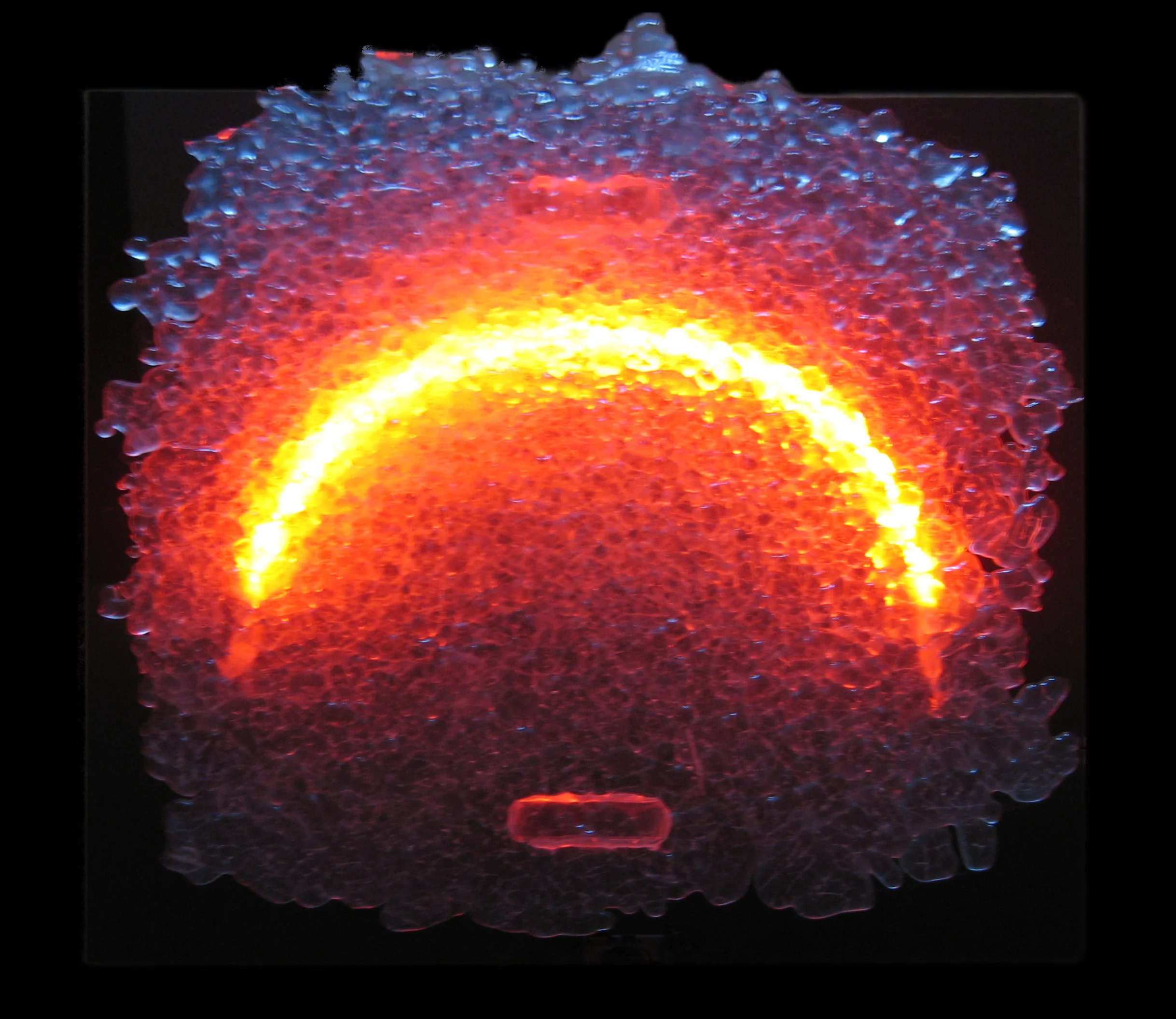 Arc, 2010. Neon tube, glass cast out of kiln. 15"H x 15" W x 3"D