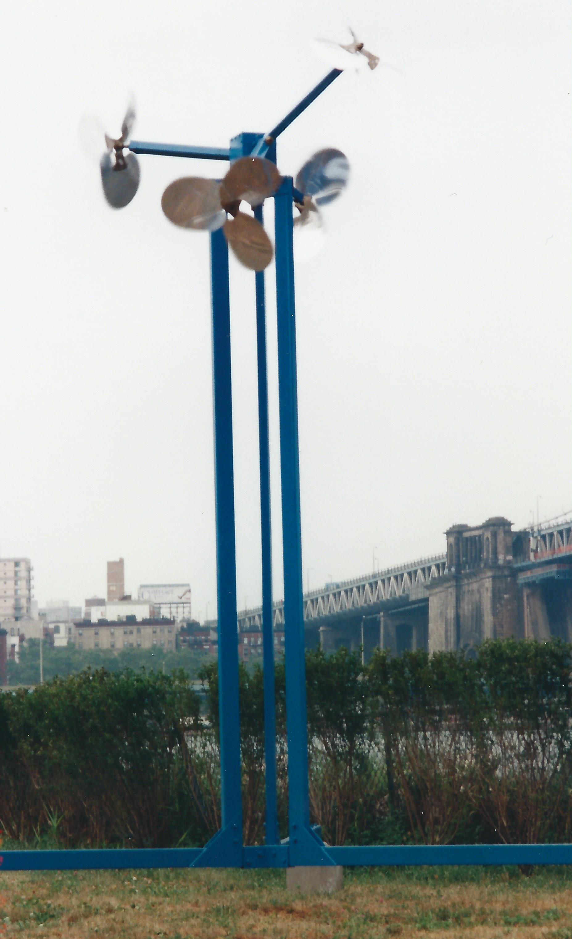Spinners, 1995. Wind driven sculpture designed for BWAC Empire Fulton Ferry State Park sculpture exhibition, Brooklyn, NY Painted steel, aluminum, cement. 20'H x 15'W x 15'D