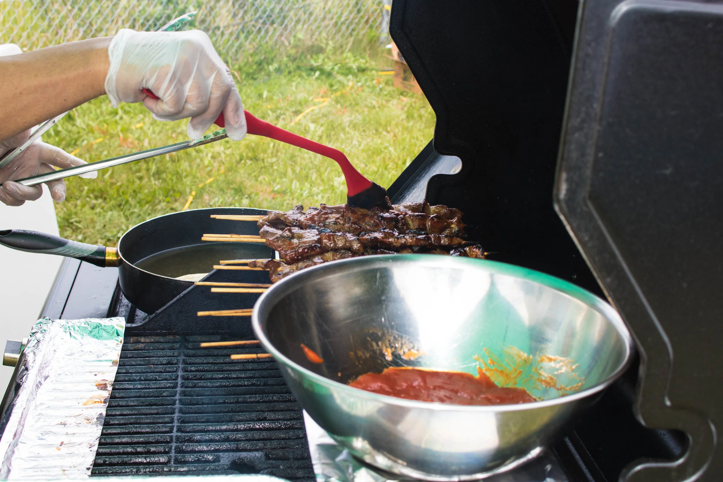 Arnold brushing down pork kebabs. Even he doesn’t know Kit’s secret marinade sauce.