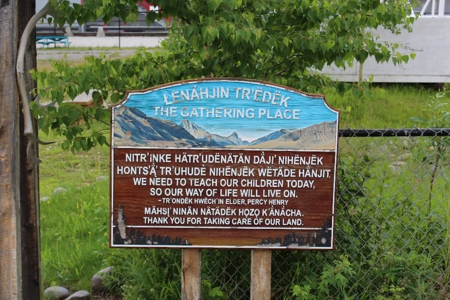 A sign entitled "The Gathering Place" stands outside the Robert Service school in Dawson city. It contains a quote about the importance of teaching children from Tr'ondek Hwech'in Elder Percy Henry. Photo by Amy Burlock.