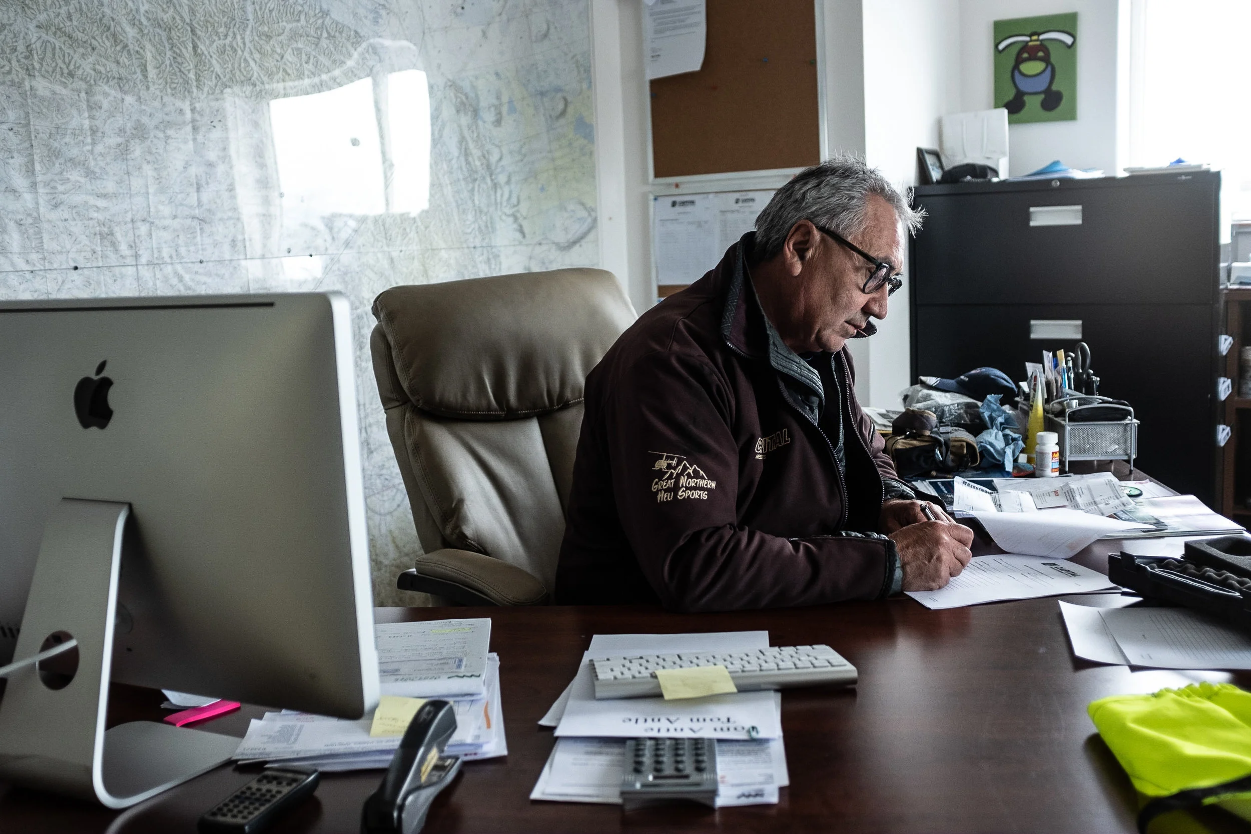 Delmar Washington, 60, spends around an hour each morning preparing paperwork and arranging flight schedules before departing on his first flight. 