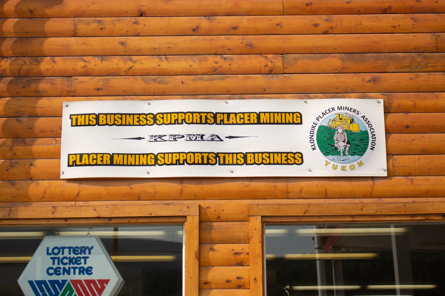 Many businesses in Dawson City hang banners showing their support of placer mining. Photo by Caroline Mercer